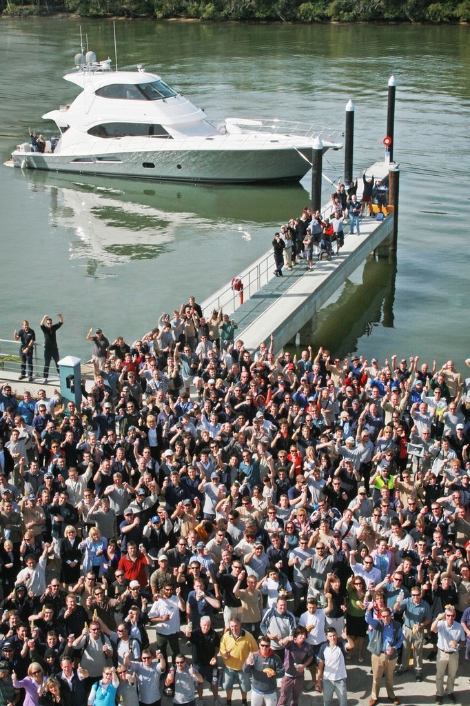 Riviera staff cheer to a successful launch for the new Riviera 70 in the background © Melissa Cameron